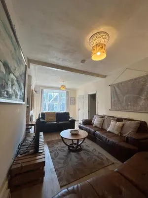 a living room with a couch and a table at Central Barmouth Town House - Near Beach - Sleeps up to 16! in Barmouth