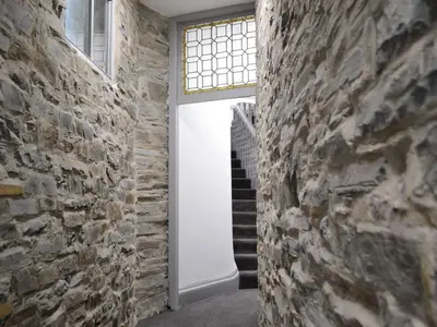 a door in a brick wall with a window at Grosvenor House APT 1 in Aberystwyth