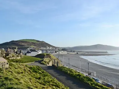 a view of a beach with houses and the ocean at Grosvenor House APT 1 in Aberystwyth