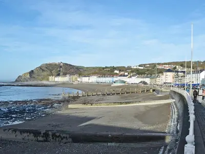 a view of a beach with buildings and the ocean at Grosvenor House APT 2 in Aberystwyth
