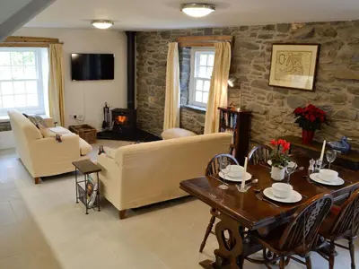 a living room with a couch and a table at The Mill in Tregaron