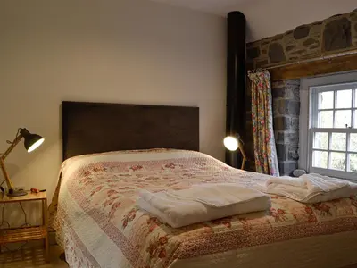 a bedroom with a bed and a window at The Mill in Tregaron
