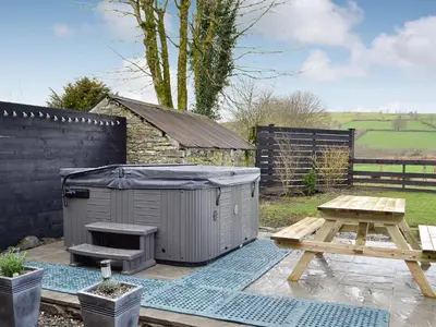 a backyard with a picnic table and a shed at Trefechan in Pumpsaint