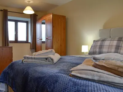 a bedroom with a bed with towels on it at Trefechan in Pumpsaint