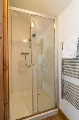 a shower with a glass door in a bathroom at Cambrian View in Aberystwyth