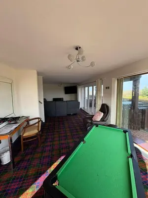 a living room with a green pool table in it at Cambrian View in Aberystwyth
