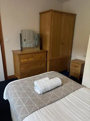 a bedroom with a bed with a towel on it at Cambrian View in Aberystwyth