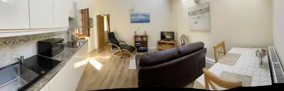 a kitchen and living room with a couch and a table at The Snicketts in Ludlow