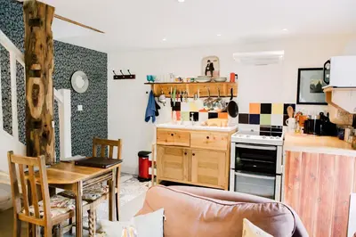 a small kitchen with a table and a stove at The Stable at Ty Beic in Bala