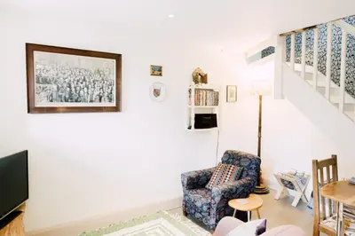 a living room with a chair and a staircase at The Stable at Ty Beic in Bala