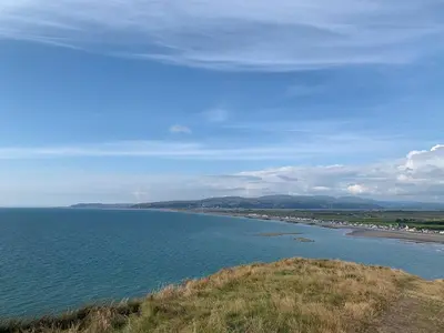 a view of a body of water with a beach at Morolwg in Borth