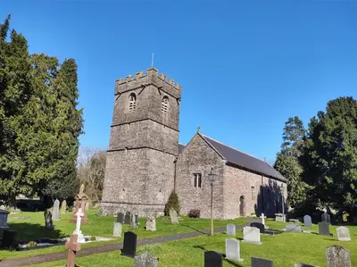 an old church with a tower in a cemetery at Penybont Barn in Llangorse