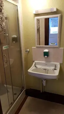 a bathroom with a sink and a shower at The Wheatsheaf Inn in Ludlow