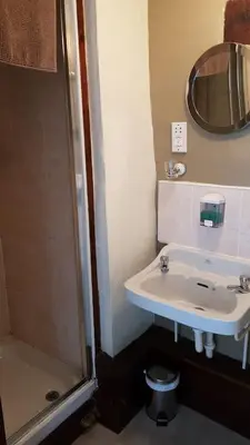 a bathroom with a sink and a shower at The Wheatsheaf Inn in Ludlow