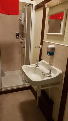 a bathroom with a sink and a shower at The Wheatsheaf Inn in Ludlow