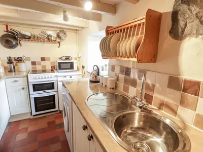 a kitchen with a sink and a stove at Plas Arenig in Blaenau-Ffestiniog