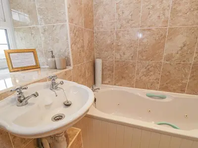 a bathroom with a sink and a bath tub at Plas Arenig in Blaenau-Ffestiniog