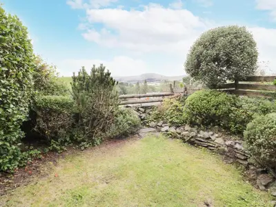 a garden with a fence and a field at Plas Arenig in Blaenau-Ffestiniog
