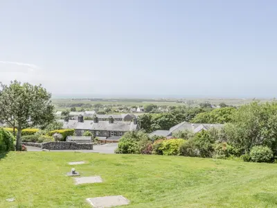 a view of a park with houses in the background at Bryn Coch Bach in Dyffryn