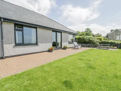 an image of a house with a lawn at Bryn Coch Bach in Dyffryn