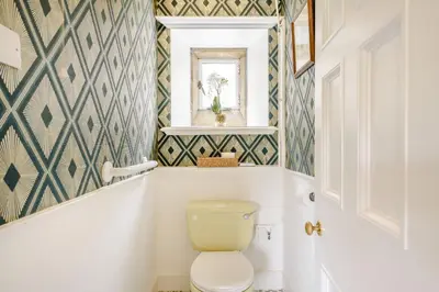 a bathroom with a toilet and a window at Plas Gwynfryn in Llanbedr