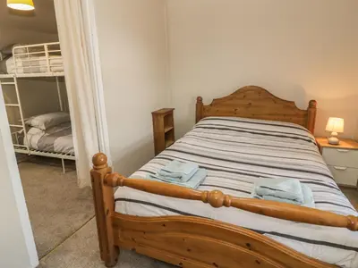 a bedroom with a bed and a bunk bed at Ty Uchaf in Dyffryn