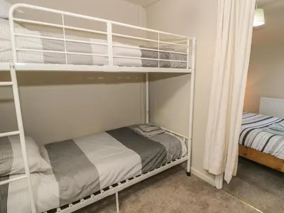 a bedroom with two bunk beds and a bed at Ty Uchaf in Dyffryn