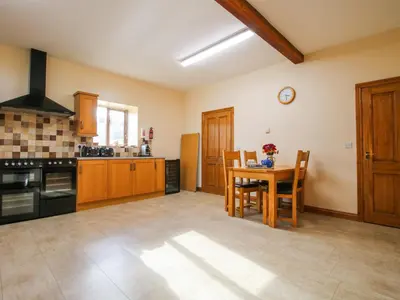 a kitchen with a table and chairs and a stove at The Mill House in Shrewsbury