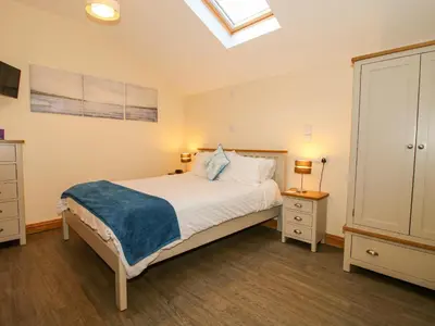 a bedroom with a bed and a skylight at The Mill House in Shrewsbury