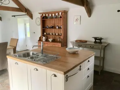 a kitchen with a sink and a counter at Cuckoo Barn at Penygaer farm near the Brecon Beacons in Llandovery