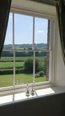 a window with a view of a green field at Upper Letton Farm in Leintwardine