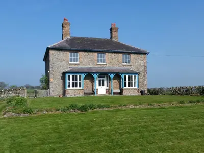 an old brick house on top of a field at Upper Letton Farm in Leintwardine