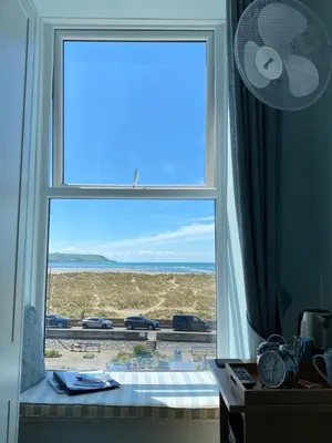 a window in a room with a view of the beach at Oceandrive in Barmouth
