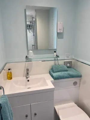 a bathroom with a sink and a mirror at Oceandrive in Barmouth