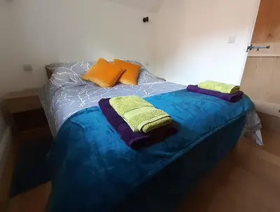 a bed with two pillows on top of it at Little Smithy in Shrewsbury