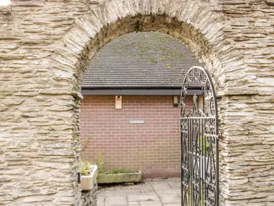 an archway in a brick building with a door at Lane House in Bishops Castle