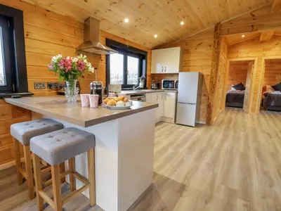 a kitchen with a large island in a log cabin at Bryn Eiddon Log Cabin in Machynlleth