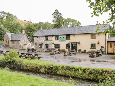 a pub with picnic tables in front of it at Stiperstones View in Shrewsbury