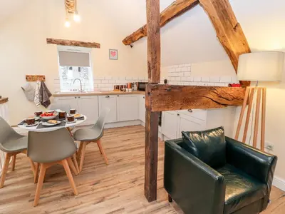 a kitchen and dining room with a table and chairs at Stabl, Plas Moelfre Hall Barns in Oswestry