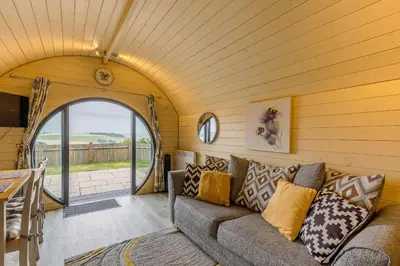 a living room with a couch and an archway at Stiperstones Pod in Shrewsbury