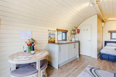 a small room with a table and a bed at Corndon Pod in Shrewsbury