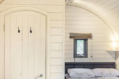 a bedroom with a bed and an arched doorway at Corndon Pod in Shrewsbury