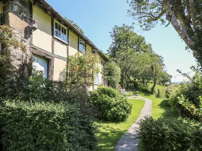 a house with a garden and a path at Lower Dolgenau- The Cottage in Caersws