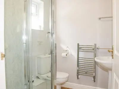 a bathroom with a toilet and a sink at The Little Dingle in Church Stretton