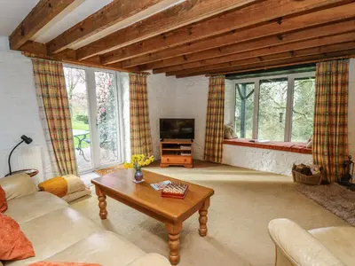 a living room with a couch and a coffee table at Trawsnant Cottage in New Quay