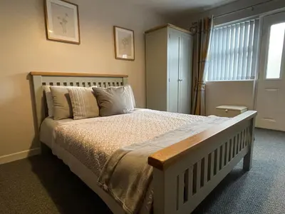 a bedroom with a large bed and a window at Westend Holiday Let 2 Brecon in Brecon