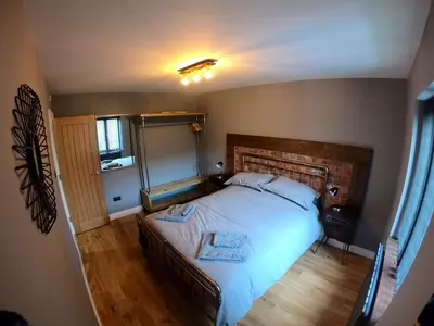 a bedroom with a large bed with two towels on it at 46 Y Lanfa in Aberystwyth