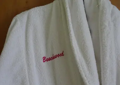 a white towel with the word bisexual written on it at Beechwood House in New Quay