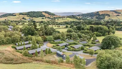 an aerial view of a farm with trees and buildings at Valley View in Rhayader