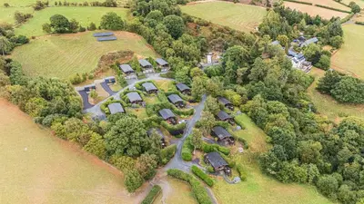 an aerial view of an estate with a group of homes at Snowy Owl Lodge in Rhayader